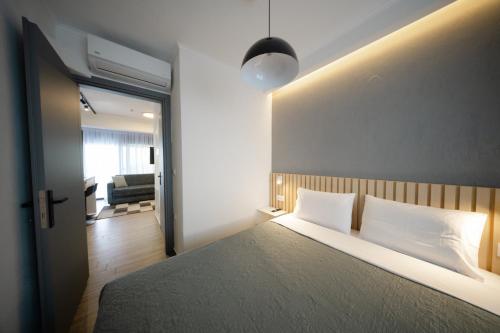 a bedroom with a large bed and a living room at Tower Luxury Flats in Alexandroupoli