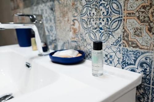 a bottle of water sitting on a sink in a bathroom at Dimora Domitia - Apartments in Mondragone
