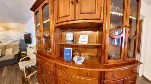 a wooden china cabinet with a bottle in it at Casa Pelaire Panticosa -tucasaenlospirineos in Panticosa
