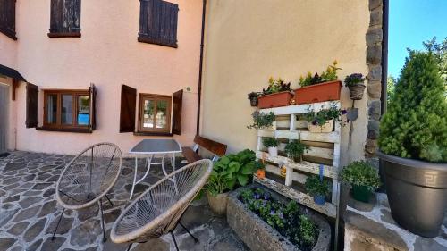 a table and chairs next to a building with plants at Casa Pelaire Panticosa -tucasaenlospirineos in Panticosa