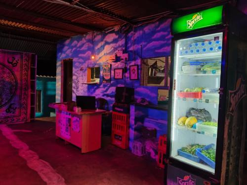 a room with an open refrigerator with purple walls at Dreamcatcher Restaurant and Guesthouse in Hampi