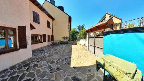 a house with a swimming pool next to a building at Casa Pelaire Panticosa -tucasaenlospirineos in Panticosa