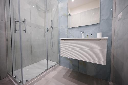 a bathroom with a shower and a sink at Dimora Domitia - Apartments in Mondragone
