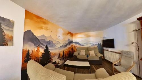 a living room with a painting of mountains on the wall at Casa Pelaire Panticosa -tucasaenlospirineos in Panticosa