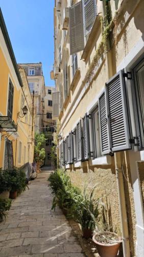 an alley with shutters on the side of a building at Serenata in Corfu Town