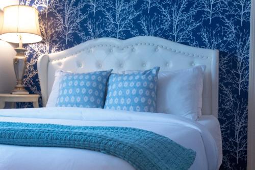 a blue bedroom with a white bed with a blue wall at Hartstone Inn in Camden