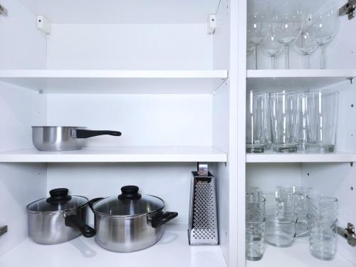 a kitchen with two pots and pans on a shelf at Ultra central, Near station 2BR 2BATH 6Sleep in Harrow