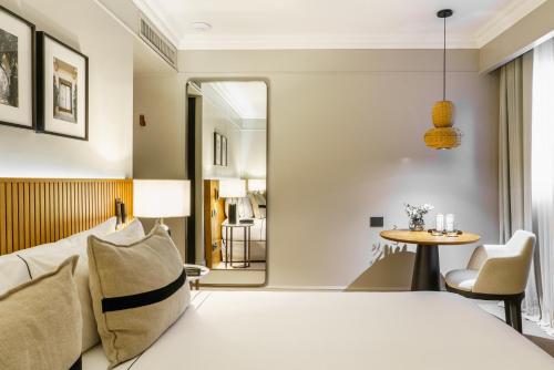 a hotel room with a bed and a table at Casa Lucia Member of Melia Collection in Buenos Aires