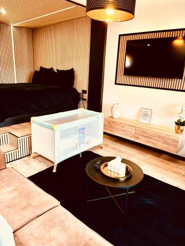 a living room with a couch and a table at Home Sweet House in Hermée