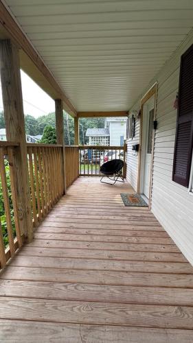 a porch of a house with a wooden deck at Milk & Honey in Glens Falls