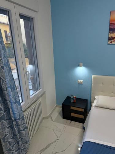 a bedroom with a bed and a window at Luna Guest House in Pisa