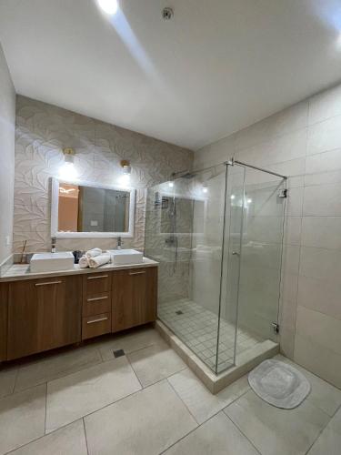 a bathroom with a shower and a sink at AmazINN Places Playa Escondida in María Chiquita