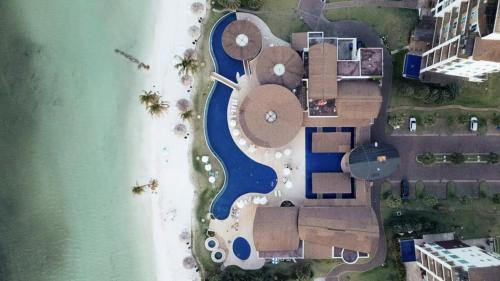 an aerial view of a resort next to the water at AmazINN Places Playa Escondida in María Chiquita