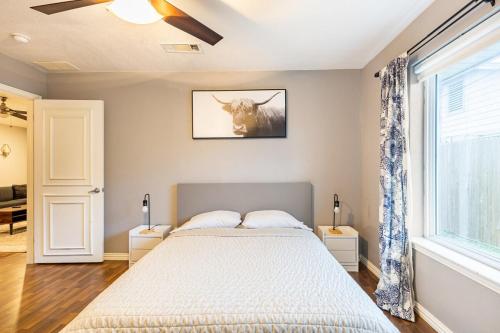 a bedroom with a bed with a cow picture on the wall at Texas Escape with pool & office in Hurst
