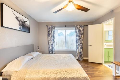 a bedroom with a bed and a ceiling fan at Texas Escape with pool & office in Hurst