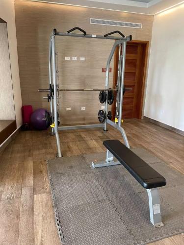 a room with a gym with a treadmill at AmazINN Places Playa Escondida in María Chiquita