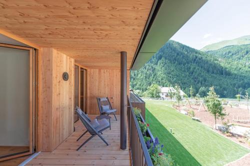 a view from the porch of a wooden house at Linara Mountain Family Stay in Valles