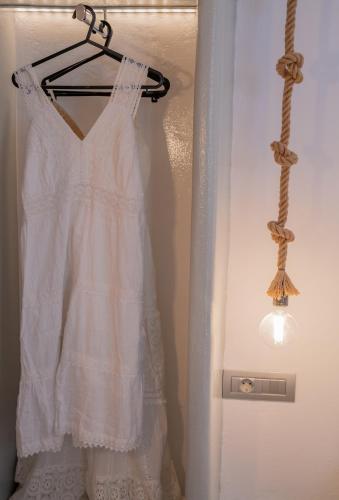 a white dress is hanging on a hanger at Pezoula Traditional House with Sunrise View in Santorini