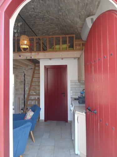 a living room with a red door and a red door at Patrika Traditional House in Patriká