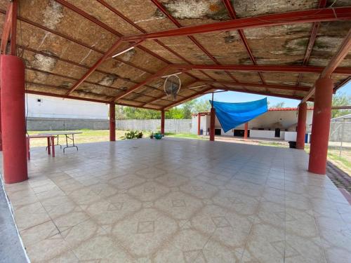 a large patio with a table and a basketball hoop at Quinta Jalisco in Ciénega de Flores