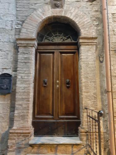 a wooden door in a stone building at Nice View in Todi