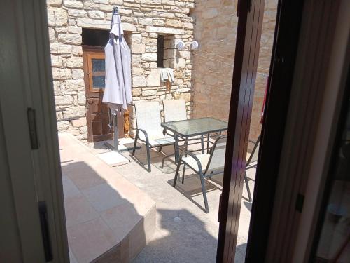 a patio with a table and chairs and an umbrella at Patrika Traditional House in Patriká