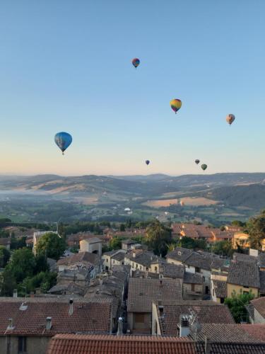 a group of hot air balloons flying over a city at Nice View in Todi
