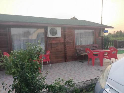 a small cabin with a table and chairs and a patio at Casa Leo in Cristur