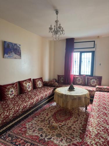 a living room with a couch and a table at Suit Home in Martil