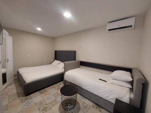a room with two beds and a chair in it at Casa Dolores - ECOline accomodation in Madrid