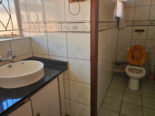 a bathroom with a sink and a toilet at Randgate guesthouse in Randfontein