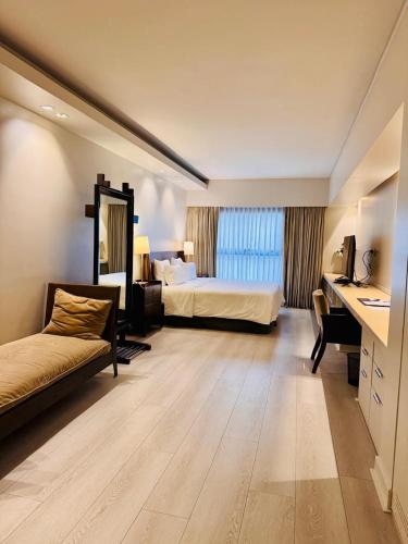 a hotel room with a bed and a desk at Libertad Hotel Buenos Aires in Buenos Aires