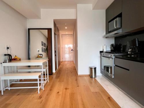 a kitchen with a wooden floor and a counter top at I811 LOFT AC premium amenities in Mexico City
