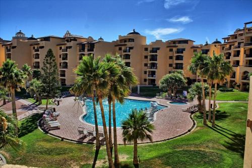 an aerial view of a resort with a pool and palm trees at Princesa -C206- Arcade Game -Experience Rocky Point- in Puerto Peñasco