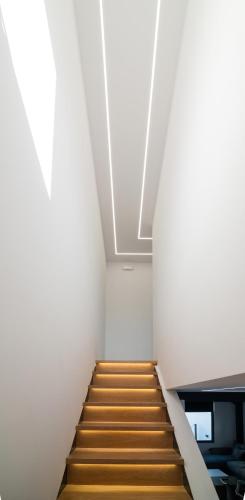 a staircase in an office building with white walls at Melydia luxury Villa in Kastamonítsa
