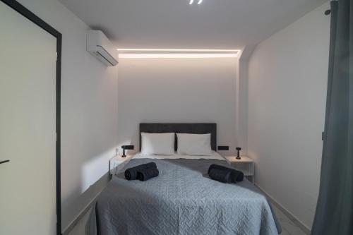 a bedroom with a bed in a white room at Melydia luxury Villa in Kastamonítsa