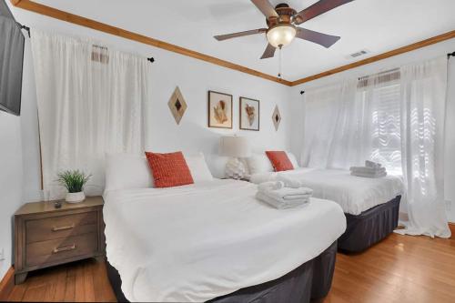 two beds in a room with a ceiling fan at Big 6br,4ba Home W 10-car Parking For Crewsgrps in Atlanta