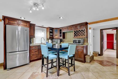 a kitchen with a table and a refrigerator at Big 6br,4ba Home W 10-car Parking For Crewsgrps in Atlanta