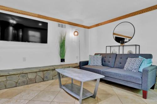 a living room with a blue couch and a table at Big 6br,4ba Home W 10-car Parking For Crewsgrps in Atlanta