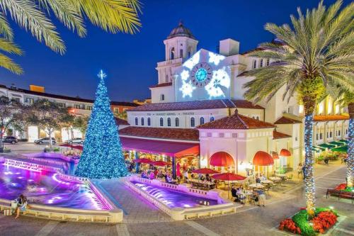 a christmas tree in front of a building with a clock tower at 4br Private Guest Suite Pool Pga Beaches in Palm Beach Gardens