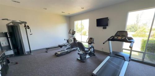 a gym with two tread machines and a flat screen tv at SureStay by Best Western Sunnyvale Silicon Valley in Sunnyvale