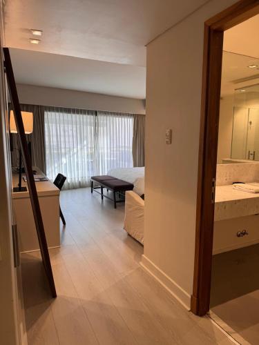 a room with a bedroom and a bed and a mirror at Libertad Hotel Buenos Aires in Buenos Aires