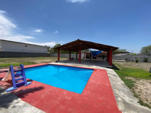 a swimming pool with a gazebo and a playground at Quinta Jalisco in Ciénega de Flores