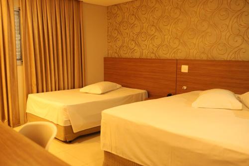 Ένα ή περισσότερα κρεβάτια σε δωμάτιο στο Indaiá Park Hotel