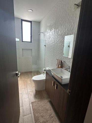a bathroom with a sink and a toilet at Luxor and Condo Hotel in Ajijic