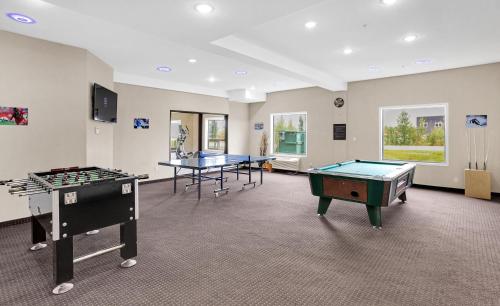 a room with two ping pong tables in it at Duvernay Inn & Suites in Fox Creek
