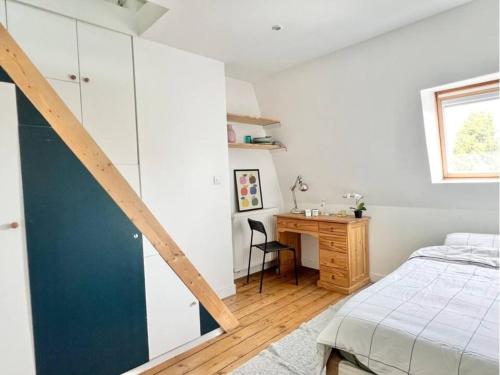 a bedroom with a bed and a desk and a window at Chambre privée - Proche Lille in Ronchin