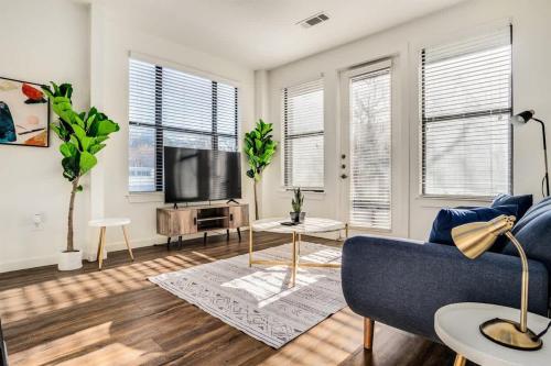 a living room with a blue couch and a tv at Boulevard Stays Walk to Downtown 1BR SoCo Pool Parking Gym 06 in Austin