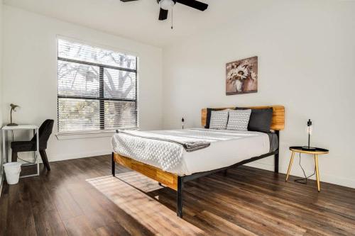 a white bedroom with a bed and a window at Boulevard Stays Walk to Downtown 1BR SoCo Pool Parking Gym 06 in Austin