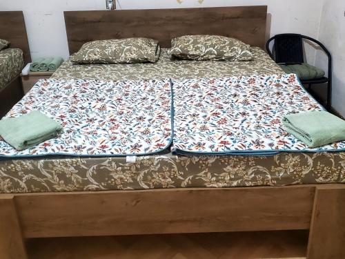 a bed with two sheets and pillows on it at City center house in Kutaisi